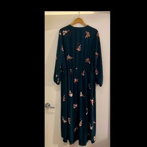 Dark green long dress with pink flowers on it.